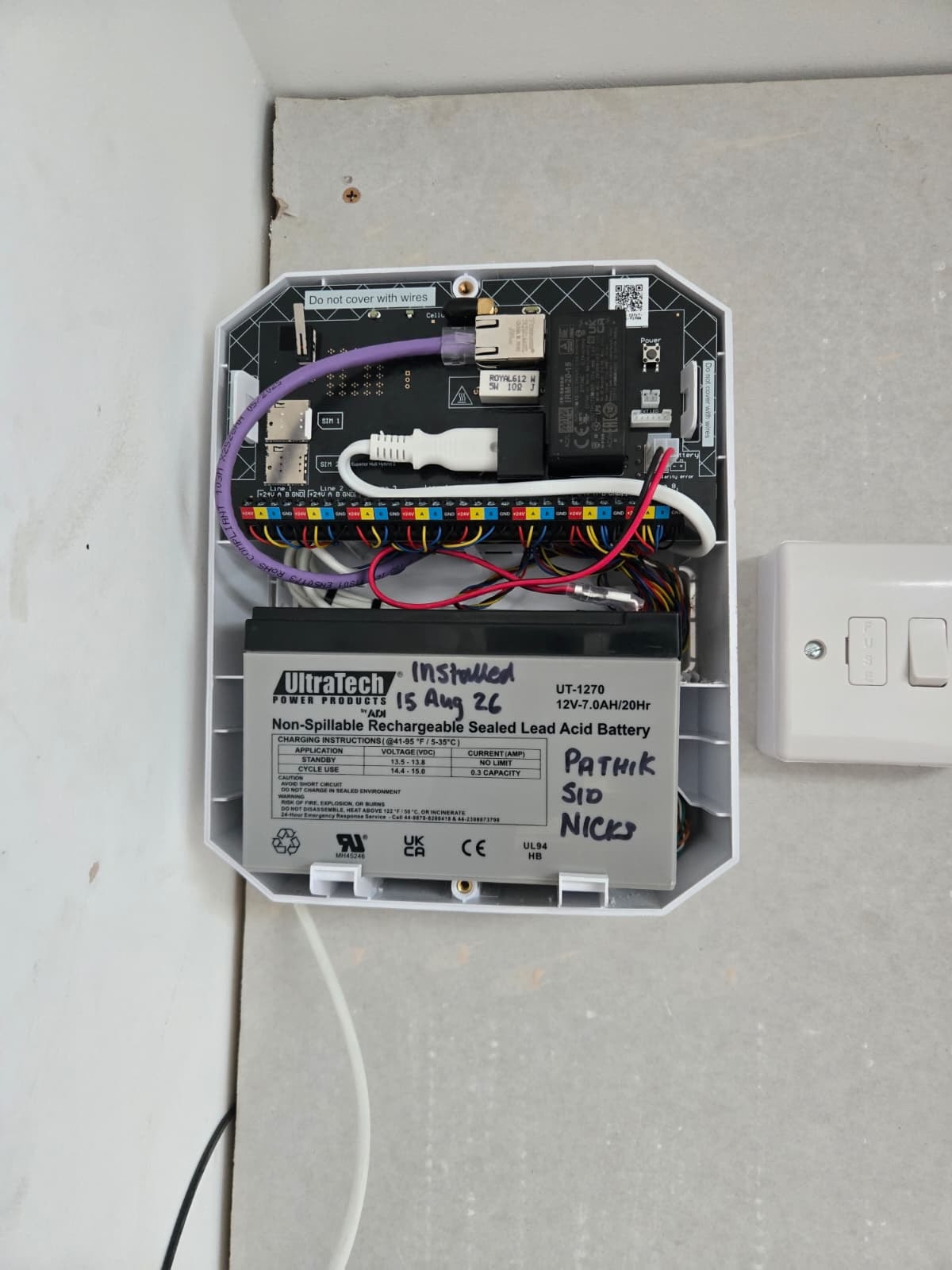 Intruder alarm panel with battery backup installed